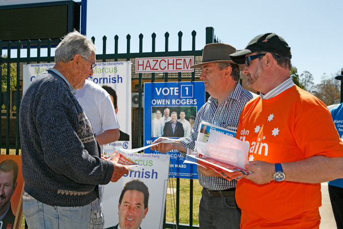 Ross Fowler and John Thain handing out how-to-vote cards at the 2012 Election 