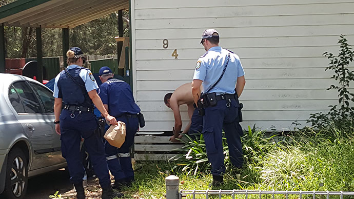 A police officer receives treatment after being contaminated by OC spray. Photo: TNV